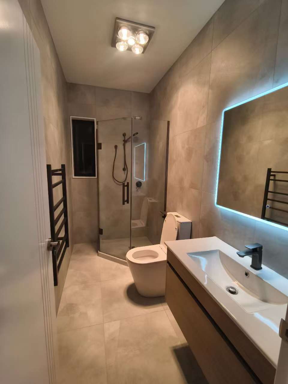 Bathroom vanity with large mirror and white basin